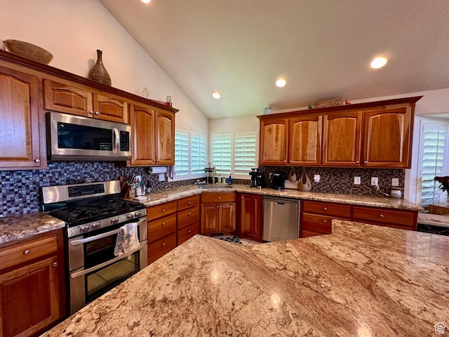 1710 N 2625 E, Layton, UT 84040 - kitchen featuring appliances with stainless steel finishes, lofted ceiling, light stone counters, decorative backsplash, and recessed lighting