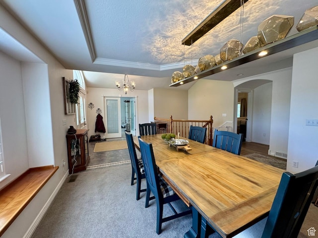 1710 N 2625 E, Layton, UT 84040 - carpeted dining room with arched walkways, a chandelier, baseboards, a raised ceiling, and crown molding