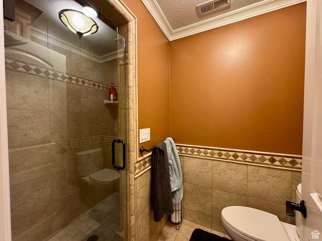 1710 N 2625 E, Layton, UT 84040 - full bath with toilet, crown molding, a shower stall, a wainscoted wall, and tile walls