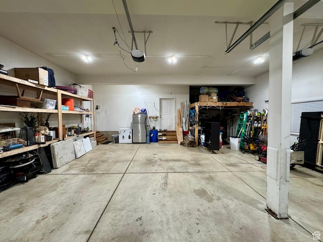 1710 N 2625 E, Layton, UT 84040 - garage with a garage door opener, freestanding refrigerator, and a workshop area