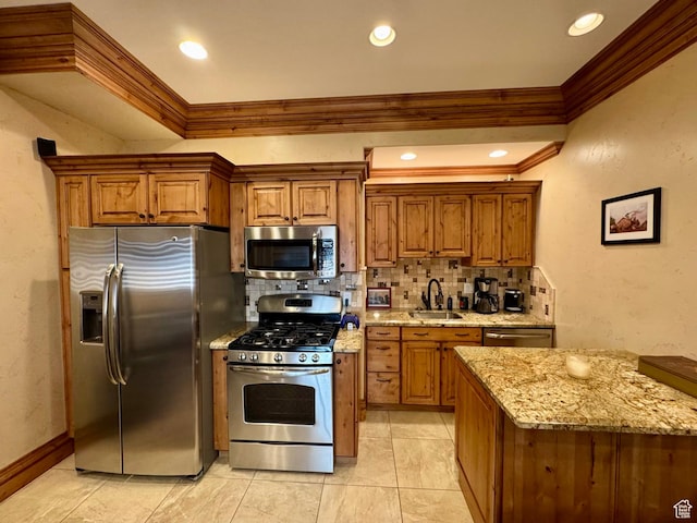 1710 N 2625 E, Layton, UT 84040 - kitchen featuring stainless steel appliances, a sink, crown molding, tasteful backsplash, and brown cabinetry
