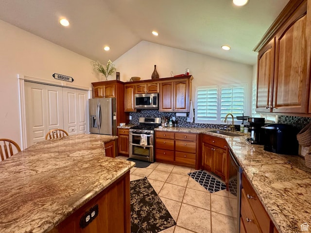 1710 N 2625 E, Layton, UT 84040 - kitchen with stainless steel appliances, a sink, tasteful backsplash, light stone counters, and vaulted ceiling