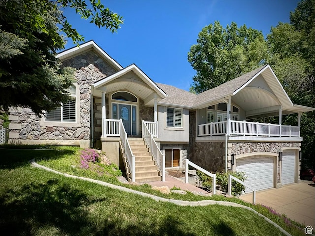 1710 N 2625 E, Layton, UT 84040 - view of front of house featuring stone siding, driveway, a garage, a shingled roof, and stairs