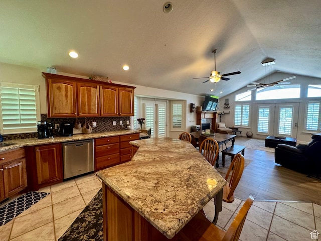 1710 N 2625 E, Layton, UT 84040 - kitchen featuring dishwasher, vaulted ceiling, ceiling fan, open floor plan, and tasteful backsplash