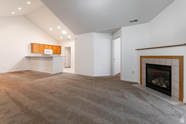 544 W 300 S Unit C, Springville, UT 84663 - unfurnished living room with light colored carpet, recessed lighting, a tile fireplace, baseboards, and high vaulted ceiling