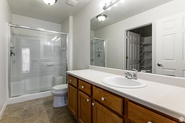 544 W 300 S Unit C, Springville, UT 84663 - bathroom featuring a shower stall, vanity, toilet, baseboards, and a textured ceiling