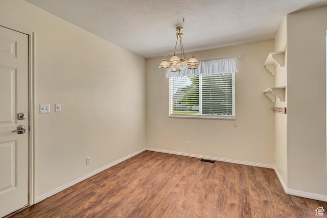 4733 S 3900 W, Roy, UT 84067 - unfurnished dining area with a chandelier, wood finished floors, baseboards, and a textured ceiling