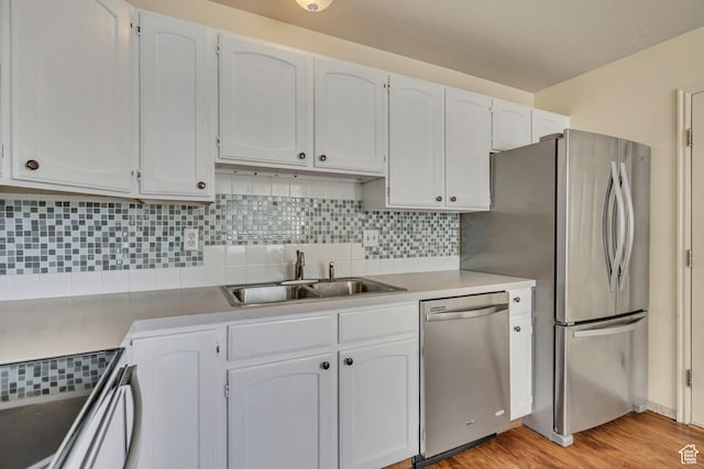 4733 S 3900 W, Roy, UT 84067 - kitchen featuring appliances with stainless steel finishes, a sink, decorative backsplash, and white cabinetry