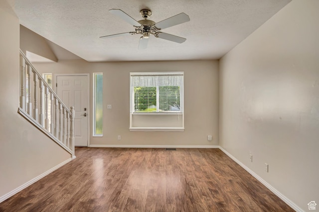4733 S 3900 W, Roy, UT 84067 - foyer entrance featuring wood finished floors, stairway, baseboards, a textured ceiling, and a ceiling fan