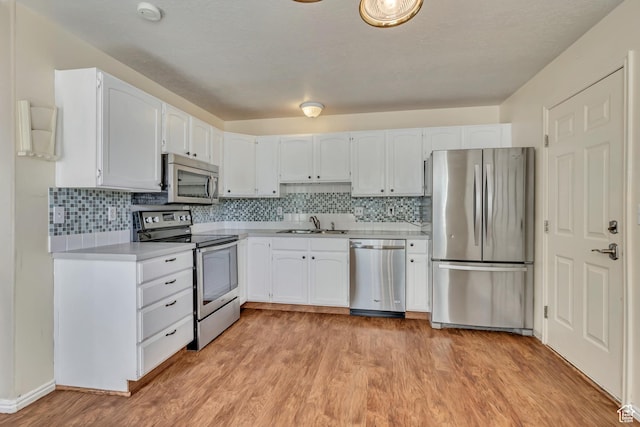 4733 S 3900 W, Roy, UT 84067 - kitchen featuring appliances with stainless steel finishes, a sink, light countertops, and white cabinetry