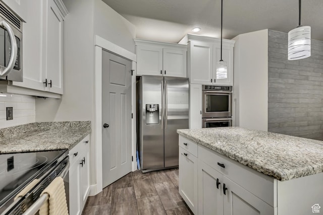 12884 S Tortoise Ln, Riverton, UT 84096 - kitchen featuring appliances with stainless steel finishes, white cabinets, dark wood-style flooring, hanging light fixtures, and recessed lighting