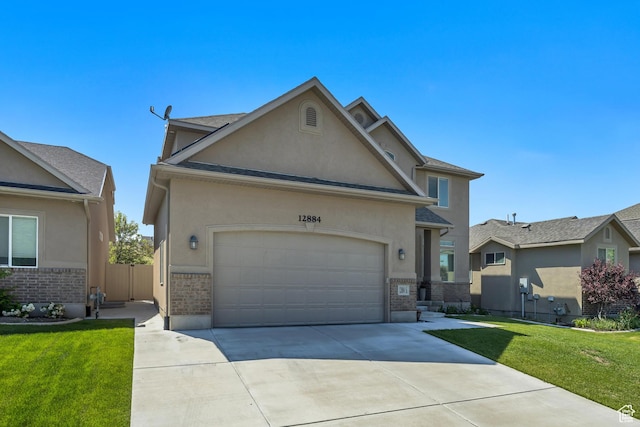 12884 S Tortoise Ln, Riverton, UT 84096 - traditional-style home featuring stucco siding, brick siding, concrete driveway, and a front lawn