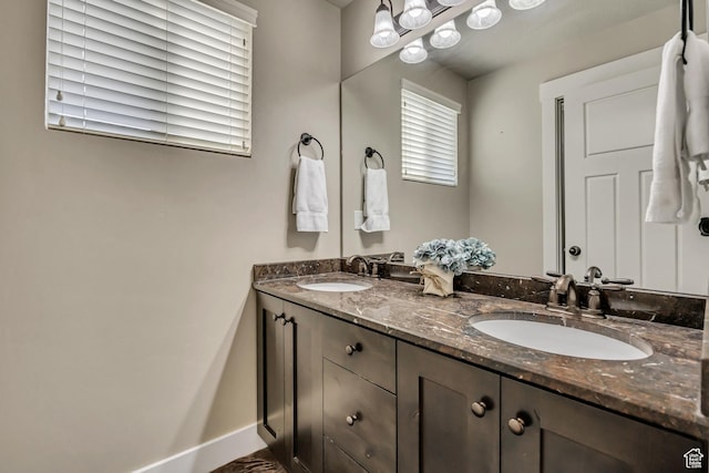 12884 S Tortoise Ln, Riverton, UT 84096 - bathroom with double vanity and baseboards