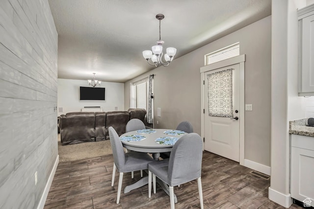 12884 S Tortoise Ln, Riverton, UT 84096 - dining room featuring a chandelier, dark wood finished floors, and baseboards