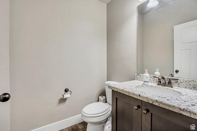 12884 S Tortoise Ln, Riverton, UT 84096 - half bath featuring vanity, toilet, baseboards, and wood finished floors