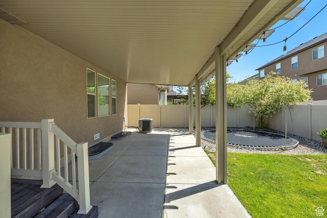 12884 S Tortoise Ln, Riverton, UT 84096 - view of patio / terrace featuring cooling unit and a trampoline