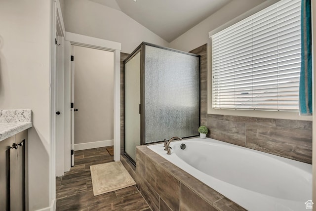 12884 S Tortoise Ln, Riverton, UT 84096 - full bathroom featuring a garden tub, a shower stall, vanity, wood finished floors, and vaulted ceiling