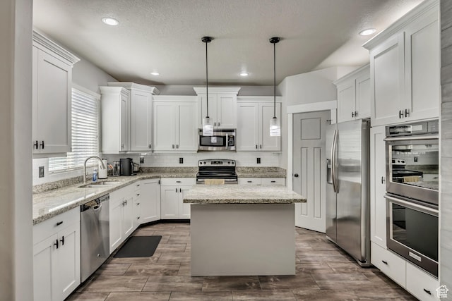 12884 S Tortoise Ln, Riverton, UT 84096 - kitchen featuring appliances with stainless steel finishes, a sink, white cabinets, decorative backsplash, and recessed lighting