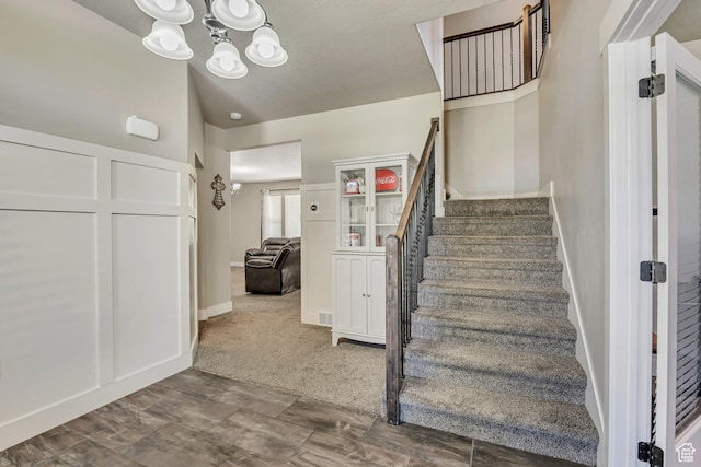 12884 S Tortoise Ln, Riverton, UT 84096 - stairs with a chandelier and baseboards