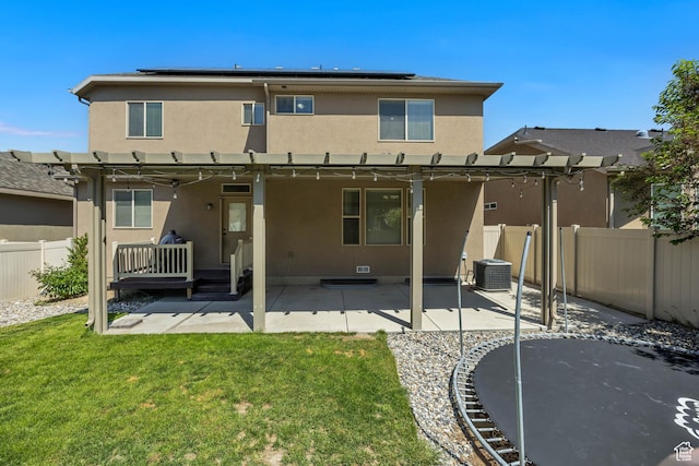 12884 S Tortoise Ln, Riverton, UT 84096 - back of house featuring stucco siding, a pergola, central AC unit, and solar panels