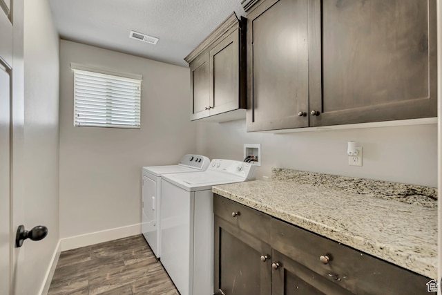 12884 S Tortoise Ln, Riverton, UT 84096 - laundry area with cabinet space, washer and clothes dryer, wood finished floors, baseboards, and a textured ceiling