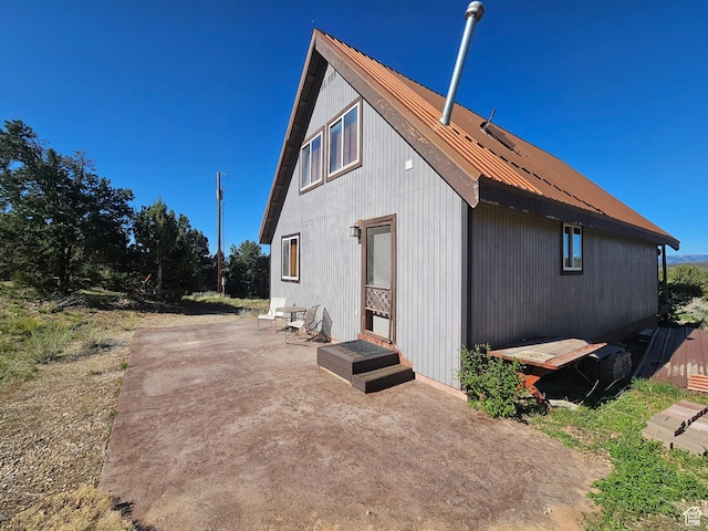 45465 W Airport Rd, Fruitland, UT 84027 - view of side of home with metal roof and a patio