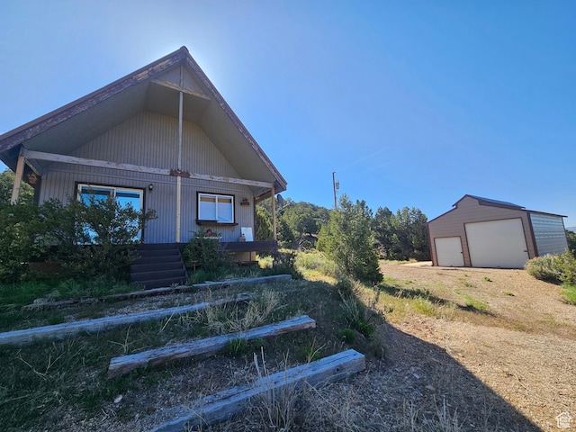 45465 W Airport Rd, Fruitland, UT 84027 - view of front of property featuring a garage, an outbuilding, and a porch