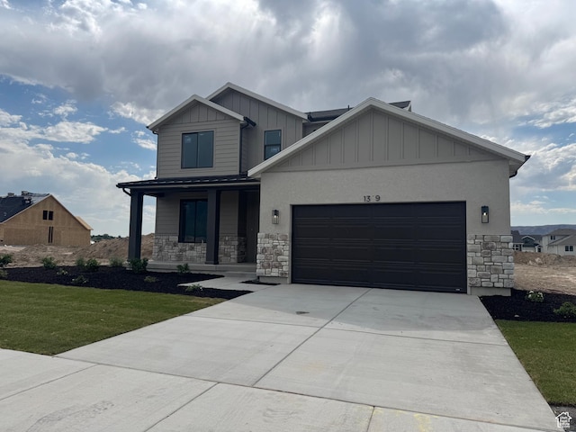 1329 N 1525 E Unit 64, Payson, UT 84651 - view of front facade with stone siding, board and batten siding, a garage, covered porch, and driveway