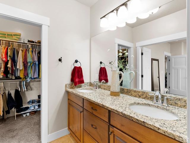 2143 W River Birch Rd, Mapleton, UT 84664 - full bath with double vanity, a spacious closet, and baseboards