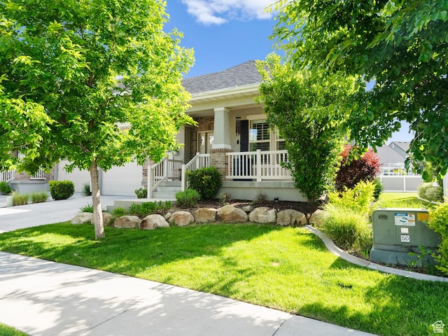 2143 W River Birch Rd, Mapleton, UT 84664 - obstructed view of property with a porch, a front yard, an attached garage, concrete driveway, and a shingled roof