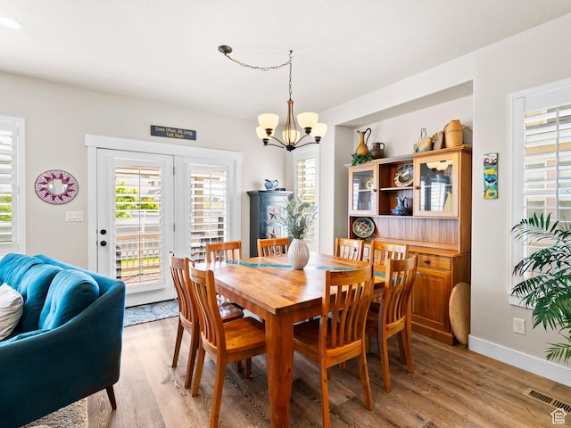 2143 W River Birch Rd, Mapleton, UT 84664 - dining space with a chandelier, plenty of natural light, and light wood-style floors