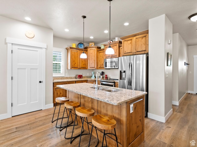 2143 W River Birch Rd, Mapleton, UT 84664 - kitchen with stainless steel appliances, a sink, light wood-type flooring, an island with sink, and recessed lighting