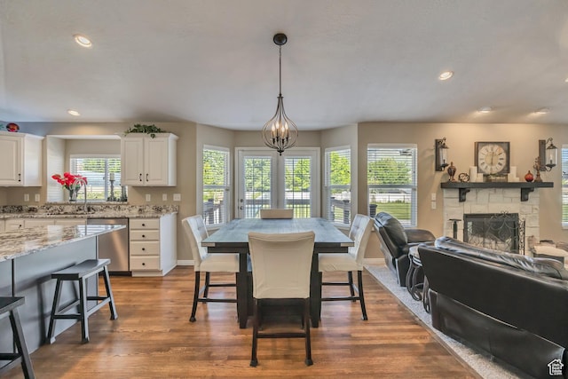 11743 S Silver Spur Ln, Draper, UT 84020 - dining space with plenty of natural light, a fireplace, dark wood-type flooring, recessed lighting, and baseboards