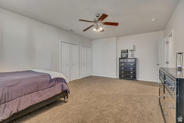 11743 S Silver Spur Ln, Draper, UT 84020 - bedroom featuring two closets, light carpet, baseboards, and a ceiling fan