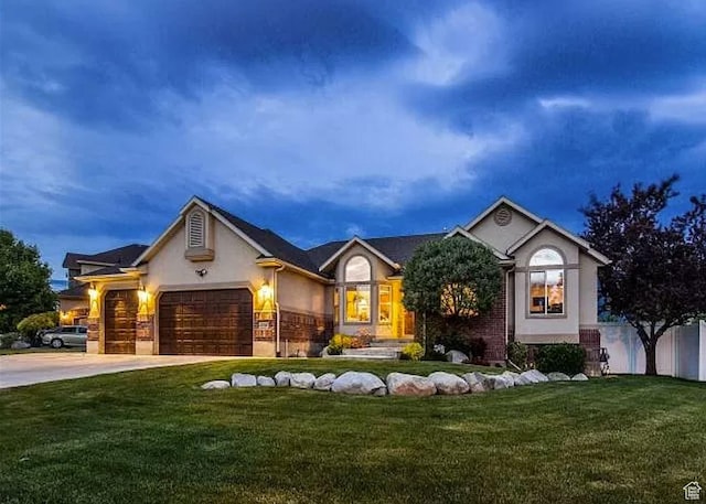 11743 S Silver Spur Ln, Draper, UT 84020 - ranch-style house with stucco siding, a front yard, a garage, and driveway
