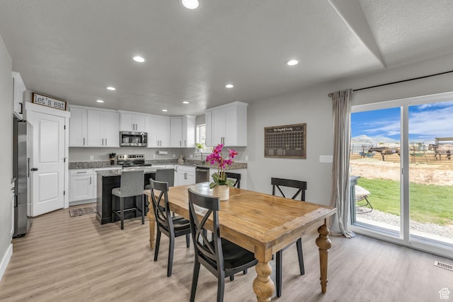 18616 Jefferson Ave, Eagle Mountain, UT 84013 - dining area featuring light wood finished floors and recessed lighting