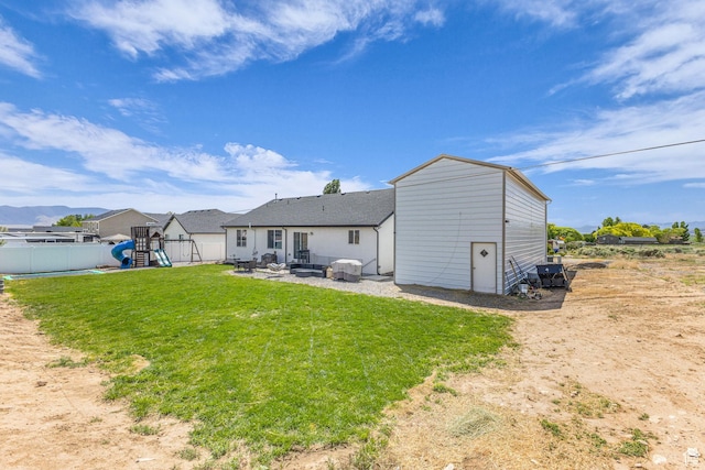 18616 Jefferson Ave, Eagle Mountain, UT 84013 - rear view of house with a playground and a patio