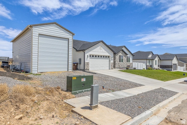 18616 Jefferson Ave, Eagle Mountain, UT 84013 - view of front facade with an attached garage, a residential view, driveway, stone siding, and board and batten siding