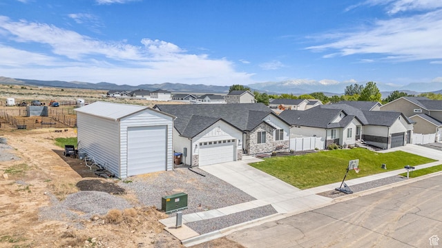 18616 Jefferson Ave, Eagle Mountain, UT 84013 - view of front facade featuring a mountain view, a residential view, stone siding, and concrete driveway