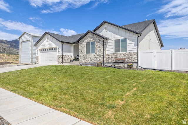 18616 Jefferson Ave, Eagle Mountain, UT 84013 - view of front of property featuring board and batten siding, stone siding, driveway, an attached garage, and roof with shingles