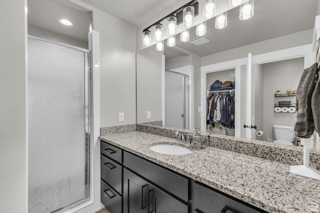 18616 Jefferson Ave, Eagle Mountain, UT 84013 - bathroom with a shower stall, vanity, a spacious closet, and toilet