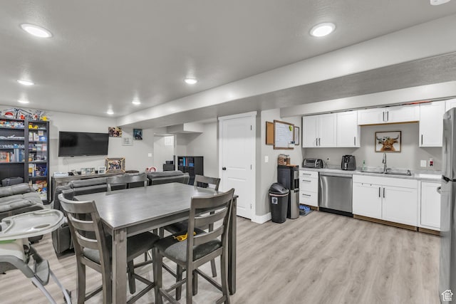 18616 Jefferson Ave, Eagle Mountain, UT 84013 - kitchen featuring dishwasher, a sink, white cabinets, light wood finished floors, and recessed lighting