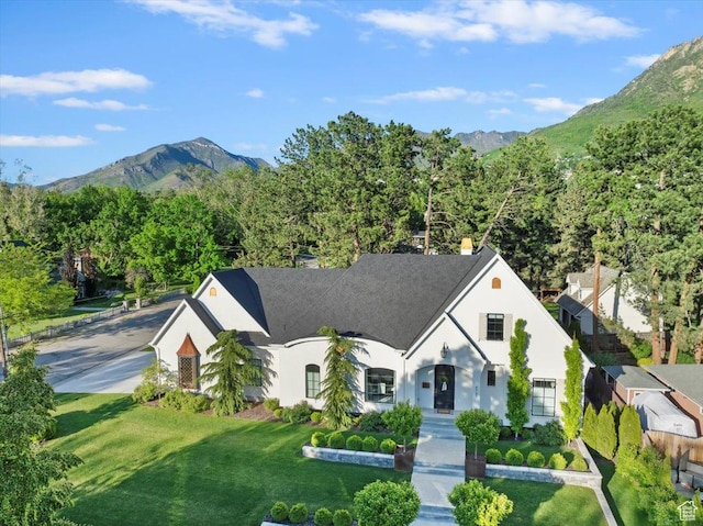 4731 S Marabow Cir, Holladay, UT 84117 - french country style house featuring a mountain view, a front yard, and stucco siding