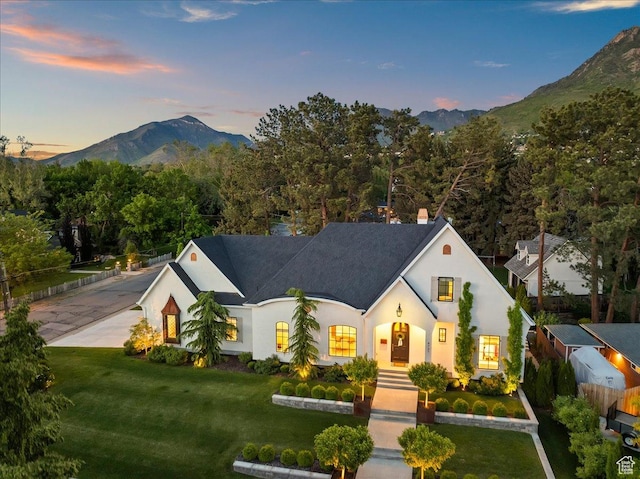 4731 S Marabow Cir, Holladay, UT 84117 - view of front of house featuring a mountain view, a front lawn, stucco siding, and a chimney