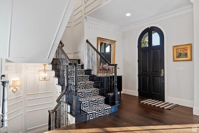 4731 S Marabow Cir, Holladay, UT 84117 - entrance foyer featuring baseboards, wood finished floors, crown molding, arched walkways, and stairs