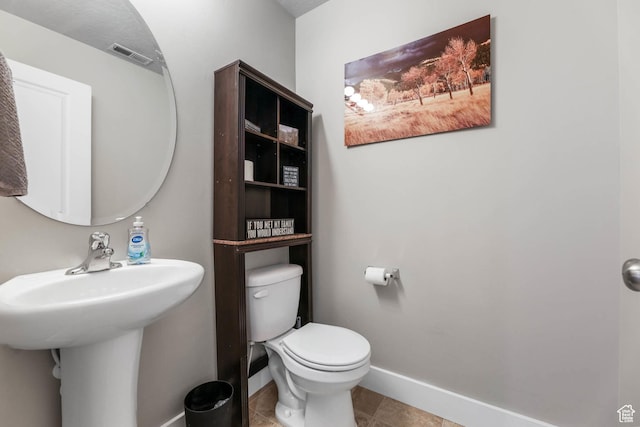 5564 W Baldrine Ct, Herriman, UT 84096 - half bathroom with baseboards, toilet, tile patterned floors, and a sink