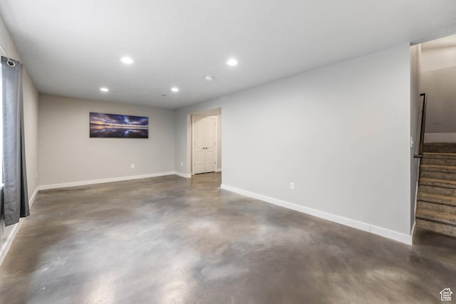 5564 W Baldrine Ct, Herriman, UT 84096 - unfurnished living room with finished concrete floors, recessed lighting, baseboards, and stairs