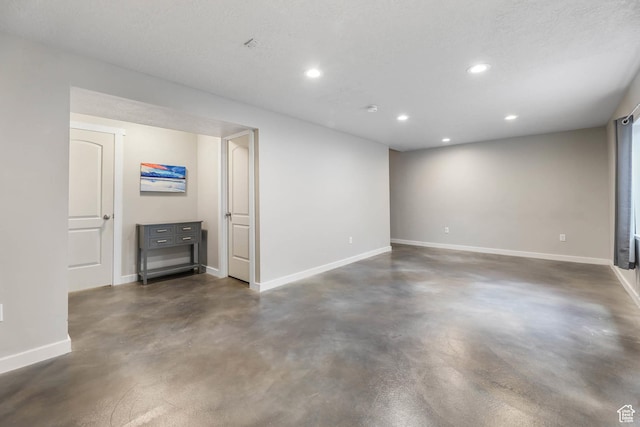 5564 W Baldrine Ct, Herriman, UT 84096 - unfurnished living room featuring concrete flooring, recessed lighting, and baseboards