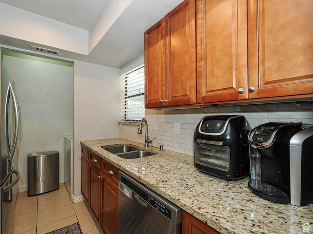 7208 S Station Creek Ln Unit 4B, Cottonwood Heights, UT 84047 - kitchen featuring stainless steel appliances, a sink, decorative backsplash, light stone counters, and light tile patterned floors