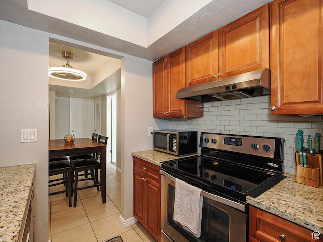 7208 S Station Creek Ln Unit 4B, Cottonwood Heights, UT 84047 - kitchen featuring stainless steel appliances, under cabinet range hood, backsplash, light tile patterned floors, and light stone countertops